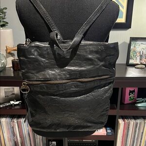 Black leather backpack with top zipper and large front pocket by Margot like new